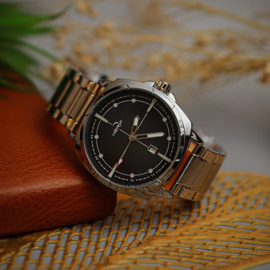 Wristwatch with silver band on a textured surface