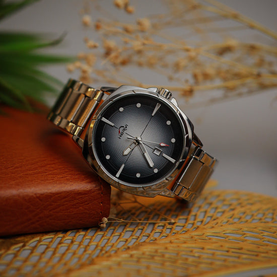 Wristwatch with silver band on a textured surface