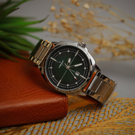 Wristwatch with silver band on a textured surface
