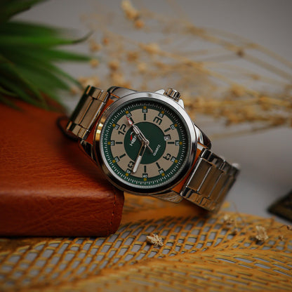 Wristwatch with green face and metal band on a textured surface