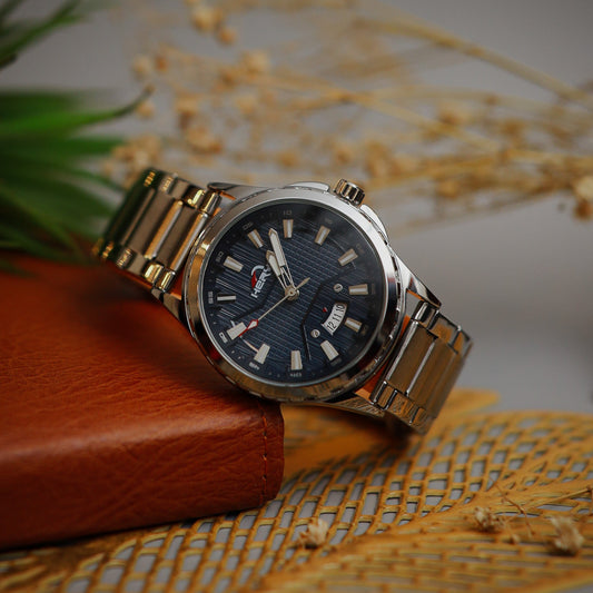 Silver watch with a blue face on a textured surface