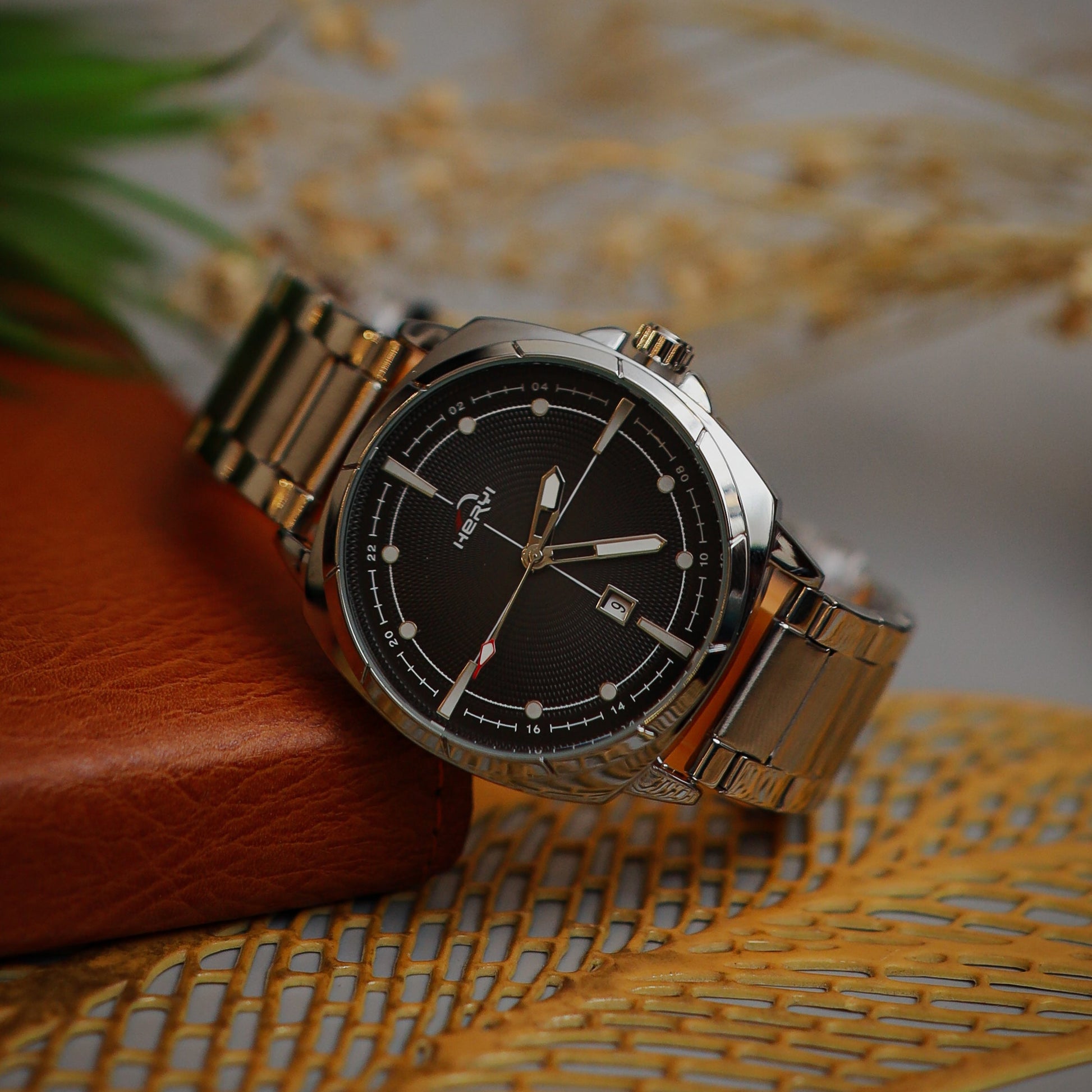 Wristwatch with silver band on a textured surface
