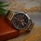 Wristwatch with silver band on a textured surface