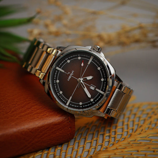 Wristwatch with silver band on a textured surface