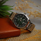 Wristwatch with silver band on a textured surface