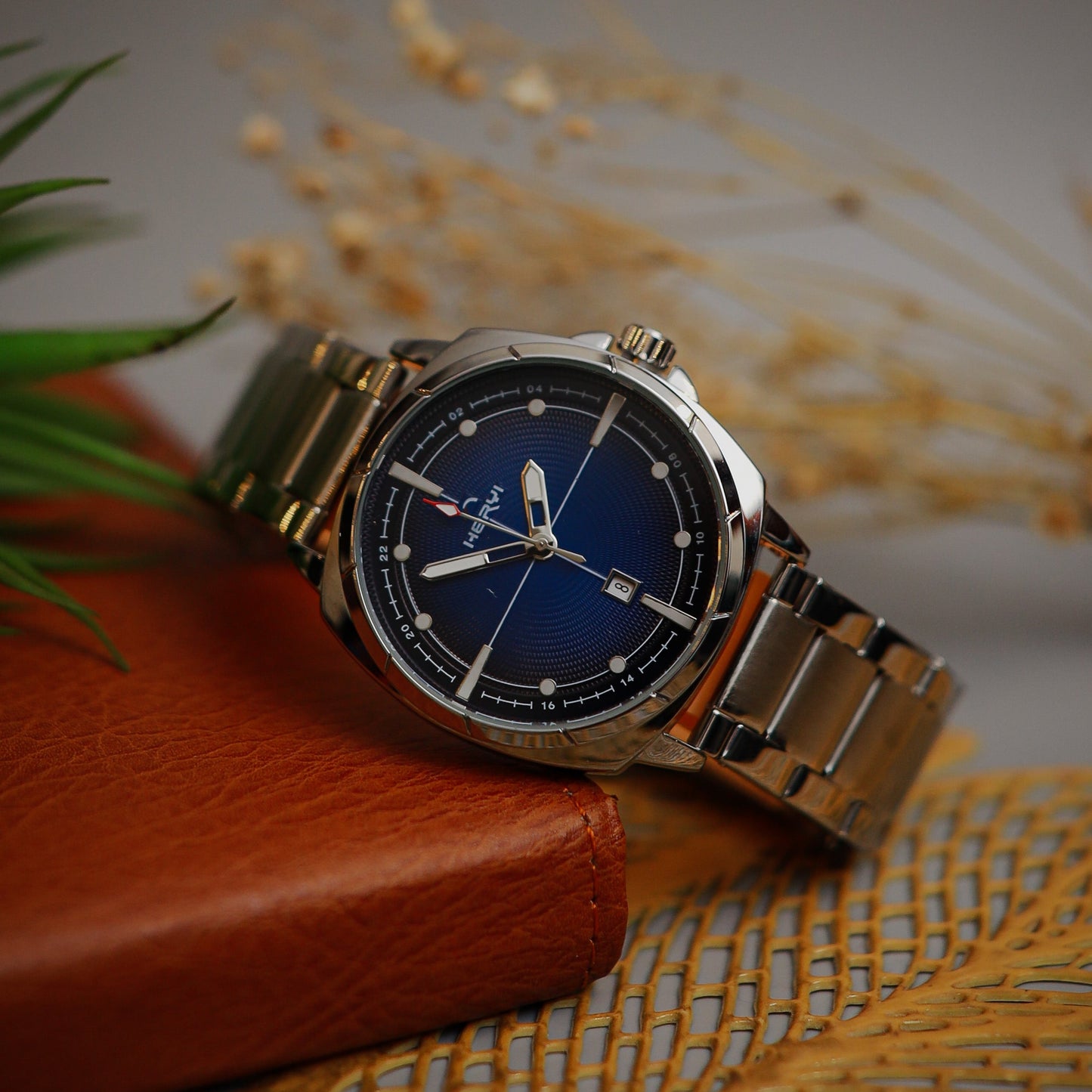 Wristwatch with silver band on a textured surface
